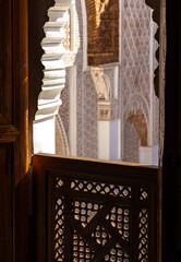 Fototapeta premium Sunlit Moorish Architecture: Intricate Carved Wood and Stucco Arches in Marrakech