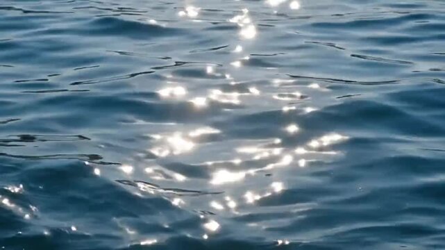 Sunlight reflecting on rippling water surface with environment reflection glitter shimmer natural outdoor ripple ocean video wave blue calm sea