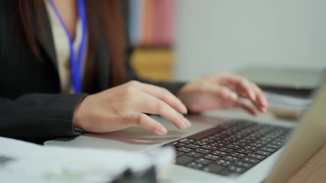 Businesswoman Typing on Laptop Computer in Modern Office Workplace
