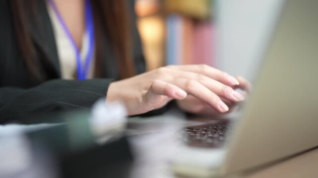 Businesswoman Typing on Laptop While Working at Office Desk