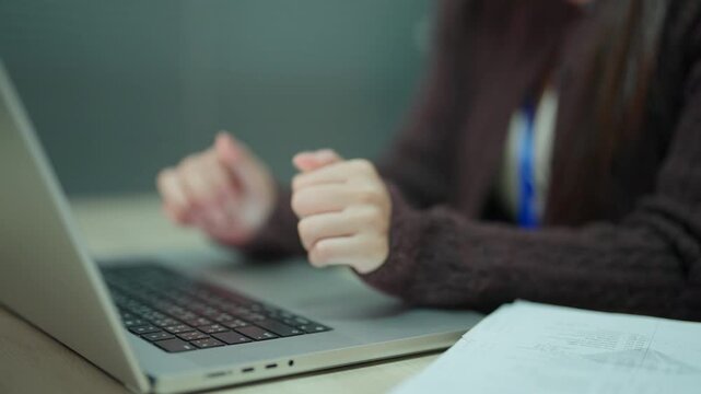 Businesswoman Typing on Laptop While Working With Financial Documents in Office