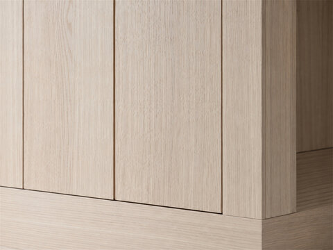 Close detail of seamless light wood cabinetry with flat panel doors precise vertical joints and clean modern millwork showing natural grain texture and minimalist built in furniture construction