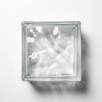 Single square glass block with light refractions on white