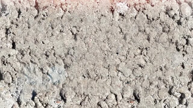 Seamless 4K looping vertical movement across a cracked rocky ground texture with dry dusty details. Great for natural backgrounds and environmental motion graphics.