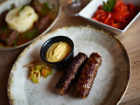 Traditional Romanian Grilled Minced Meat Rolls ("mici") Served in a Restaurant