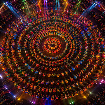 Aerial view of colorful Garba dancers forming concentric circles during a vibrant Indian cultural celebration