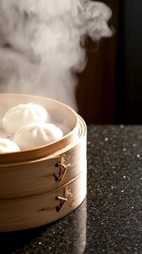 Steaming dumplings in a bamboo steamer on a dark speckled counter