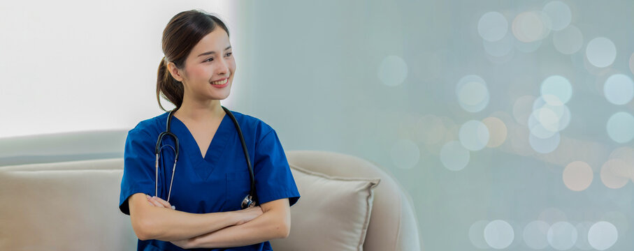 Beautiful Doctor wearing hospital  uniform seat at sofa - Cheerful Asian female  working at the hospital