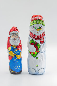 Chocolate figurines Santa snowman closeup on white.