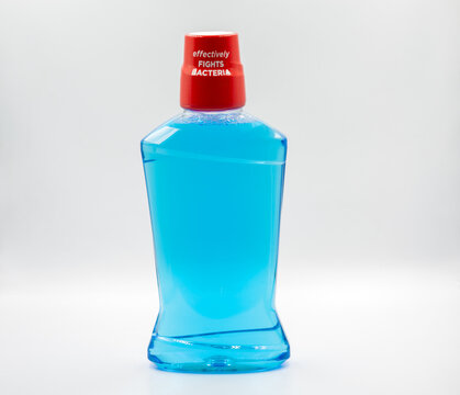 Antibacterial mouthwash bottle closeup on white.