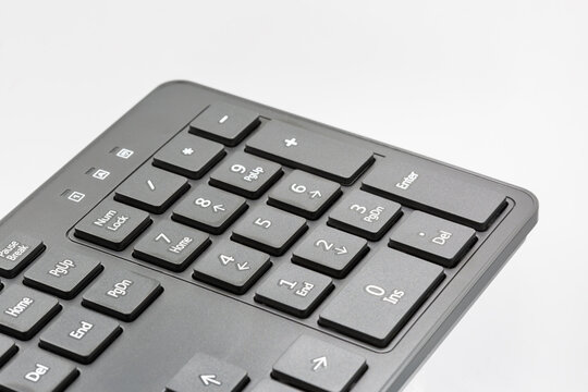 Numeric keypad of a computer keyboard, closeup on white.