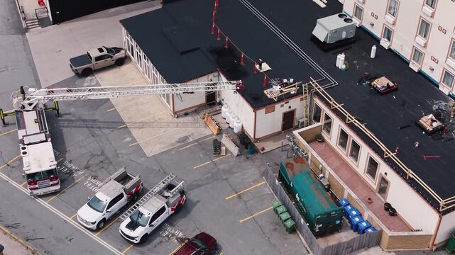 Fire trucks surround a hotel in Halifax, Nova Scotia, as people gather outside after being evacuated. The urgency of the situation is palpable as responders take action