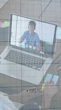 Animation of financial graphs and data over african american female designer having video call