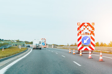 Truck and barricades marking highway repair area