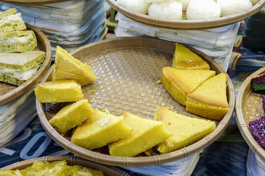 Delicious Banh dau xanh nuong, traditional baked mung bean cake slices presented in a market tray.