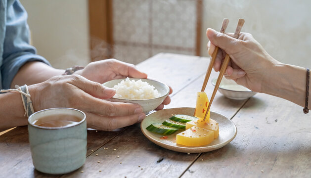 Sharing a Traditional Meal with Rice and Fresh Vegetables