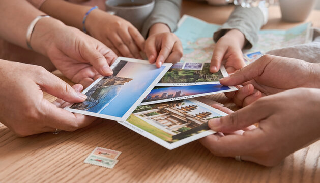 Family Members Sharing Postcards at a Table