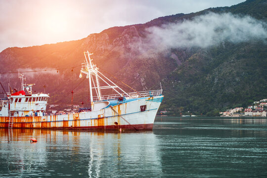Fishing trawler anchored in scenic coastal inlet