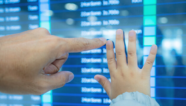Parent and Child Interacting with Flight Information Display