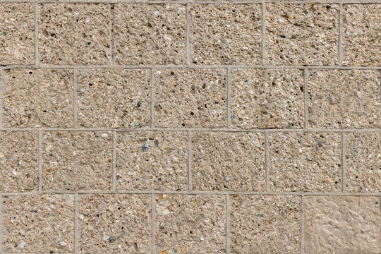 A wall of beige stone elements - seamlessly repeatable pattern
