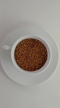 Coffee Transformation in Rotating Cup. Whole beans change into instant coffee and then a brewed drink as the cup rotates clockwise.