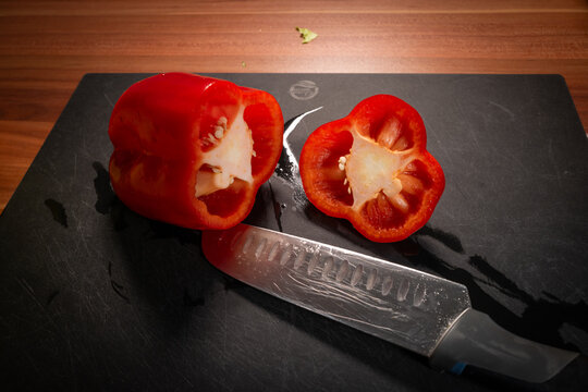 Cut Red Pepper Halves and Chef Knife Close Up