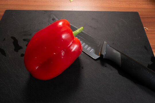 Close Up of Red Bell Pepper with Kitchen Knife