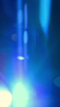 Real Anamorphic Lens Flares. Fast-changing blue in-camera lens flares and light leaks sweep across a dark background.