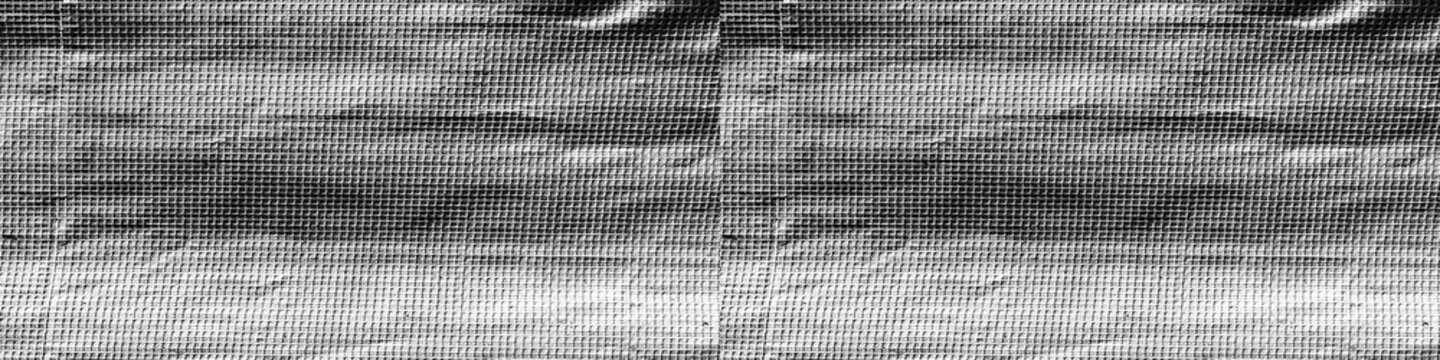 Silver metallic foil texture with reflective grid pattern, folds and creases