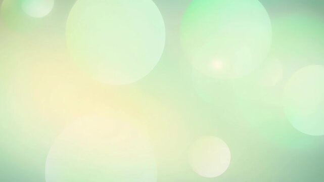 Soft pastel green and yellow bokeh background with light circular shapes for elegant design