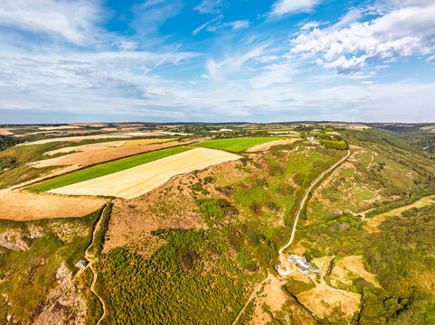 Cliffs and Farms over North Devon and Cornwall Coastpath Border from a drone, Welcombe Mouth Beach, Devon, Cornwall, England, Summer 2026