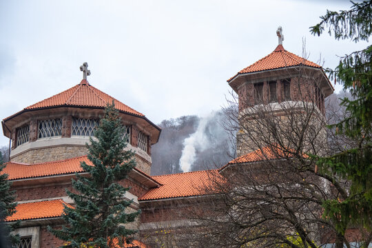 Caraiman Monastery Towers in Bușteni Against Misty Mountain Backdrop