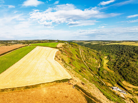 Cliffs and Farms over North Devon and Cornwall Coastpath Border from a drone, Welcombe Mouth Beach, Devon, Cornwall, England, Summer 2026