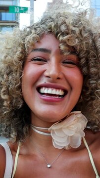 Joyful young woman laughing on a new york city street
