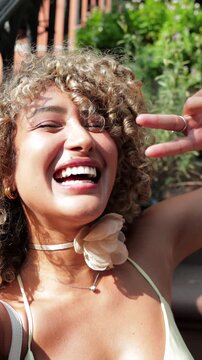 Happy curly haired woman taking selfie in manhattan new york city