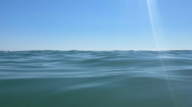 Soft ocean waves sparkling in sunlight. 4k