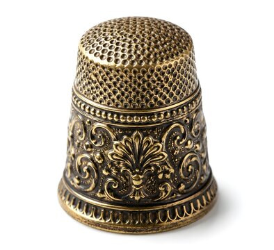 Antique Sewing Thimble With Decorative Embossed Metal Surface And Intricate Craftsmanship On White Background Photography