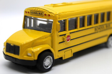Side view of yellow school toy bus with stop sign isolated on white background back to school concept  © Yousra Saleh 
