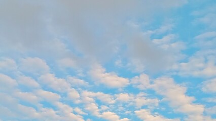 Beautiful cirrocumulus clouds looking like fish scales in the afternoon sky over a rural village. © Berti