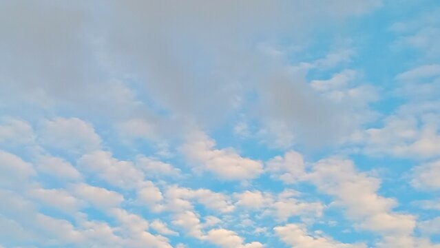 Beautiful cirrocumulus clouds looking like fish scales in the afternoon sky over a rural village.