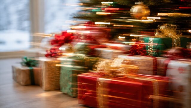 Christmas gifts under illuminated tree with colorful presents and warm motion blur, festive holiday celebration and seasonal shopping concept