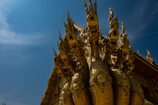 Golden Naga sculptures at Wat Sri Panton in Nan Province, Thailand, showcasing ornate Buddhist architecture, sacred craftsmanship and Northern Lanna heritage