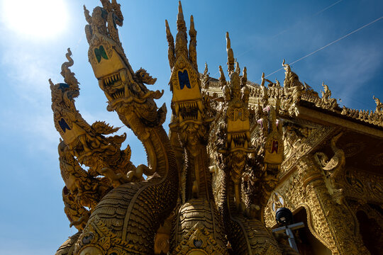 Golden Naga sculptures at Wat Sri Panton in Nan Province, Thailand, showcasing ornate Buddhist architecture, sacred craftsmanship and Northern Lanna heritage