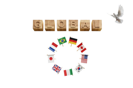 Global unity concept with wooden blocks, international flags in a circle and white dove of peace on white background