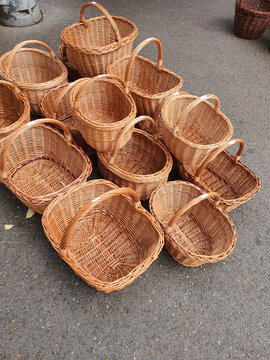 Baskets arranged on the ground for sale at a market in an outdoor area