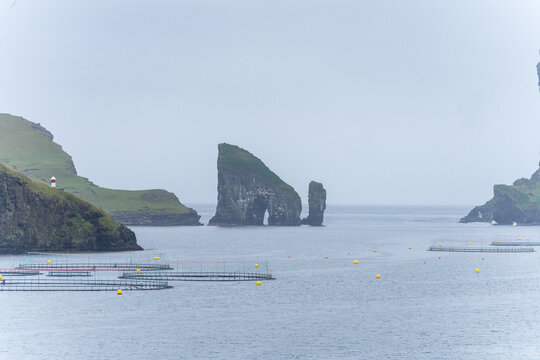 Faroe Islands Vagar exploring aquaculture and natural sea stacks of Drangarnir