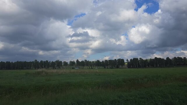 Scenic landscape with green grass and cloudy sky in rural area  