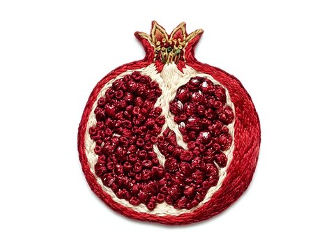 Ripe pomegranate fruit cut in half displaying deep red arils and seeds