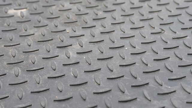 Industrial anti-slip diamond metal plate tread surface texture featuring raised grip patterns for heavy duty flooring applications
