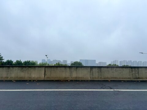 Overcast City Skyline Viewed from Highway